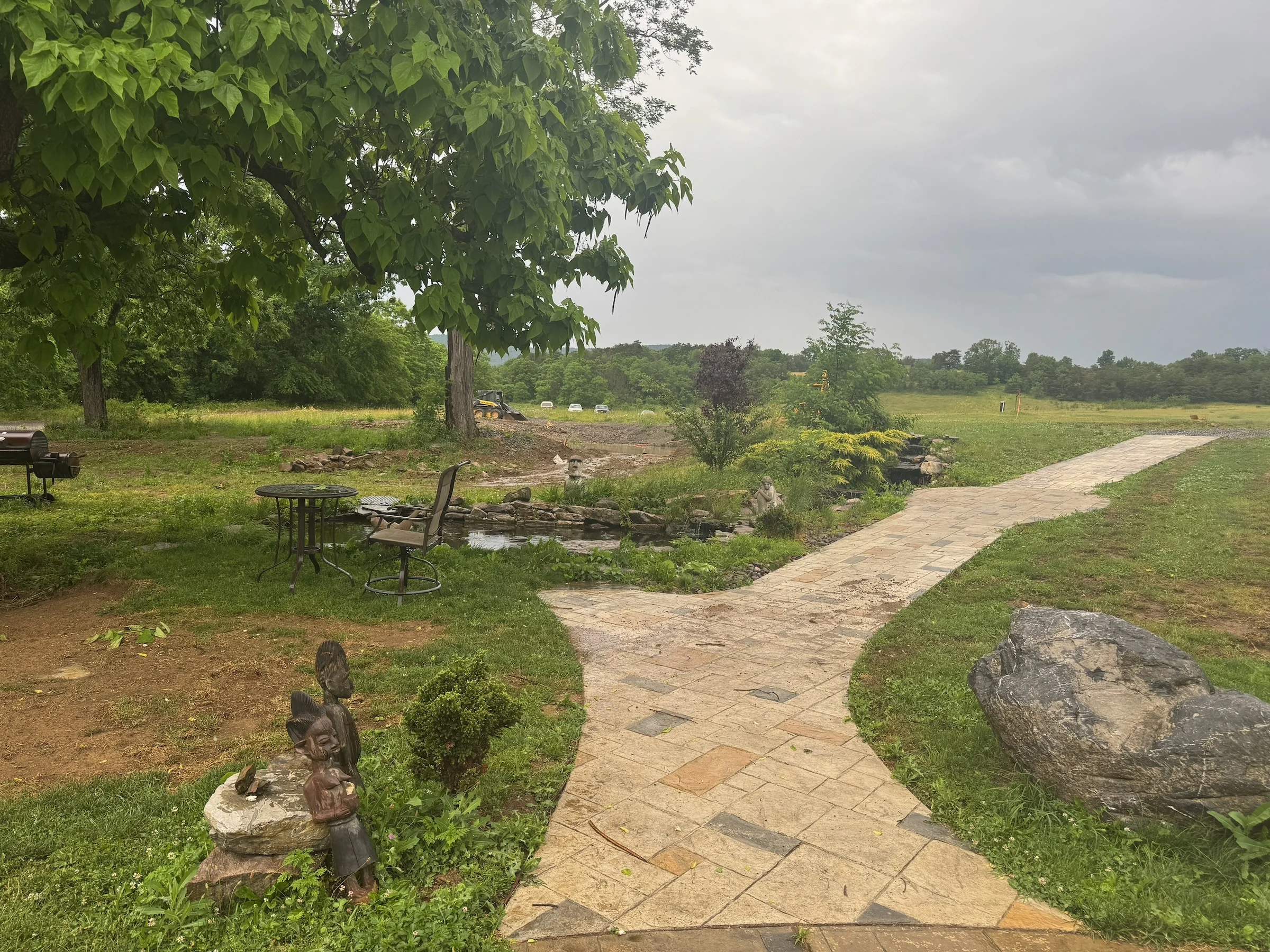 The garden and stone path looking out toward the open field.