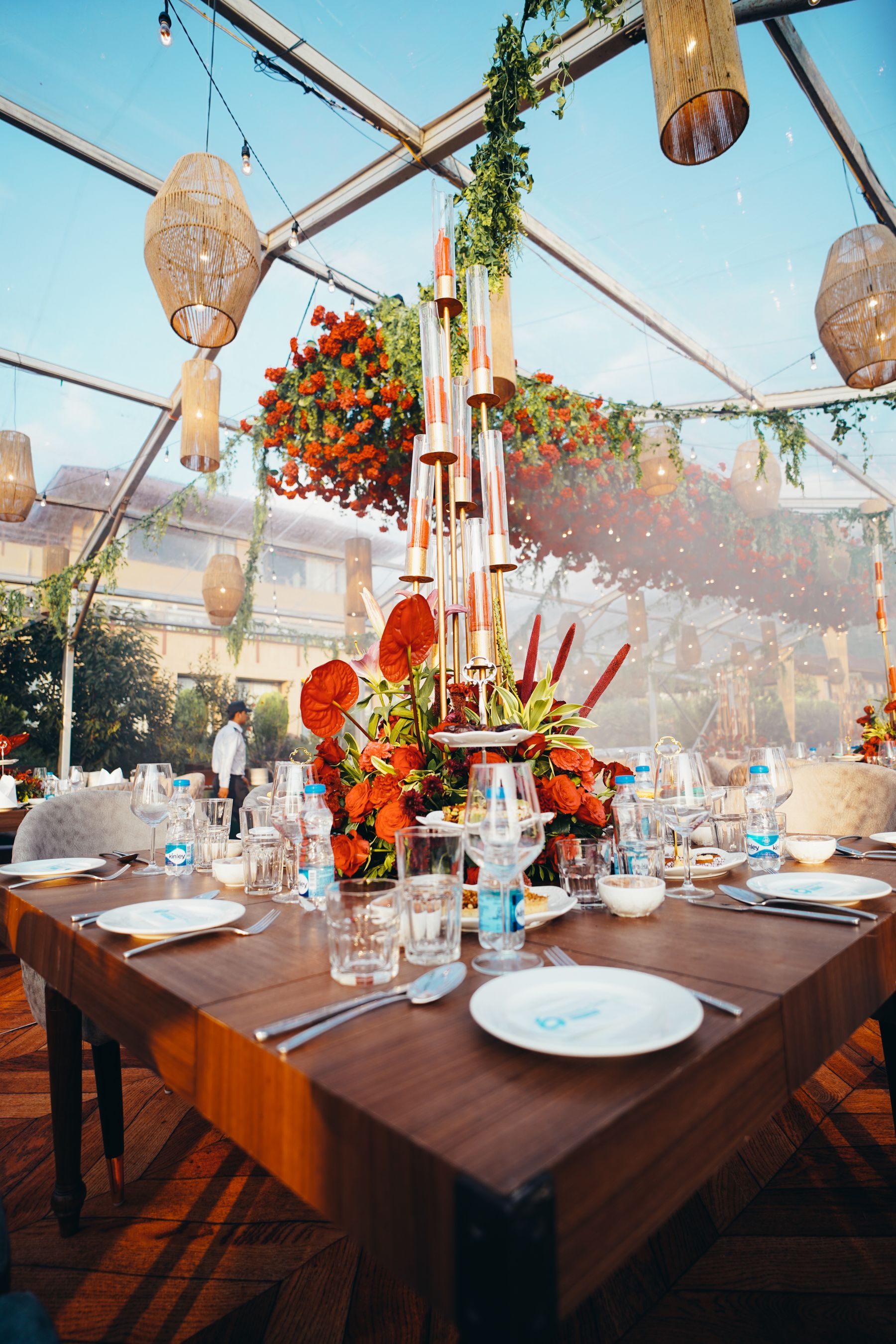 A reception table with flowers beneath a clear canopy