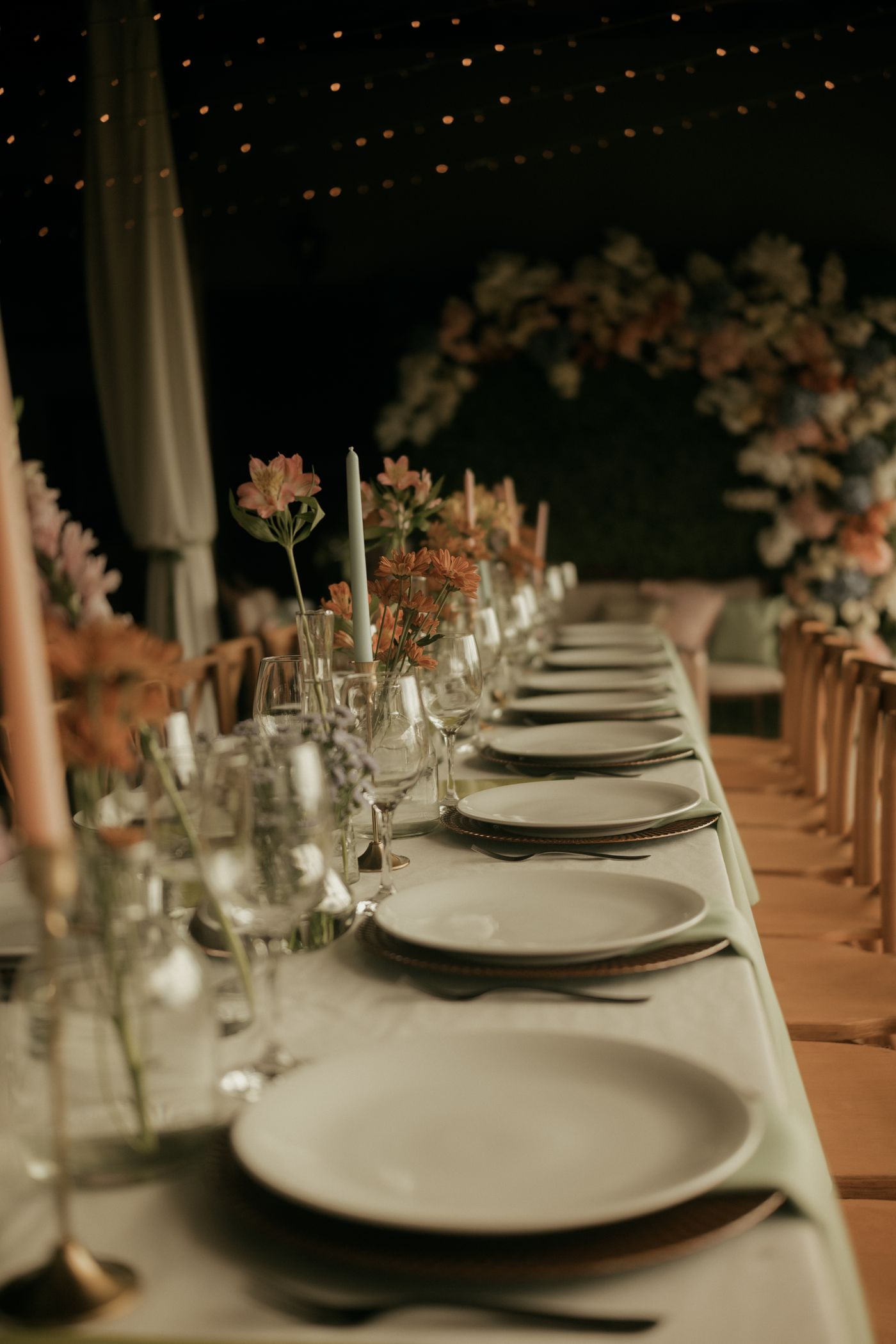 Candles, flowers and place settings on a wedding table